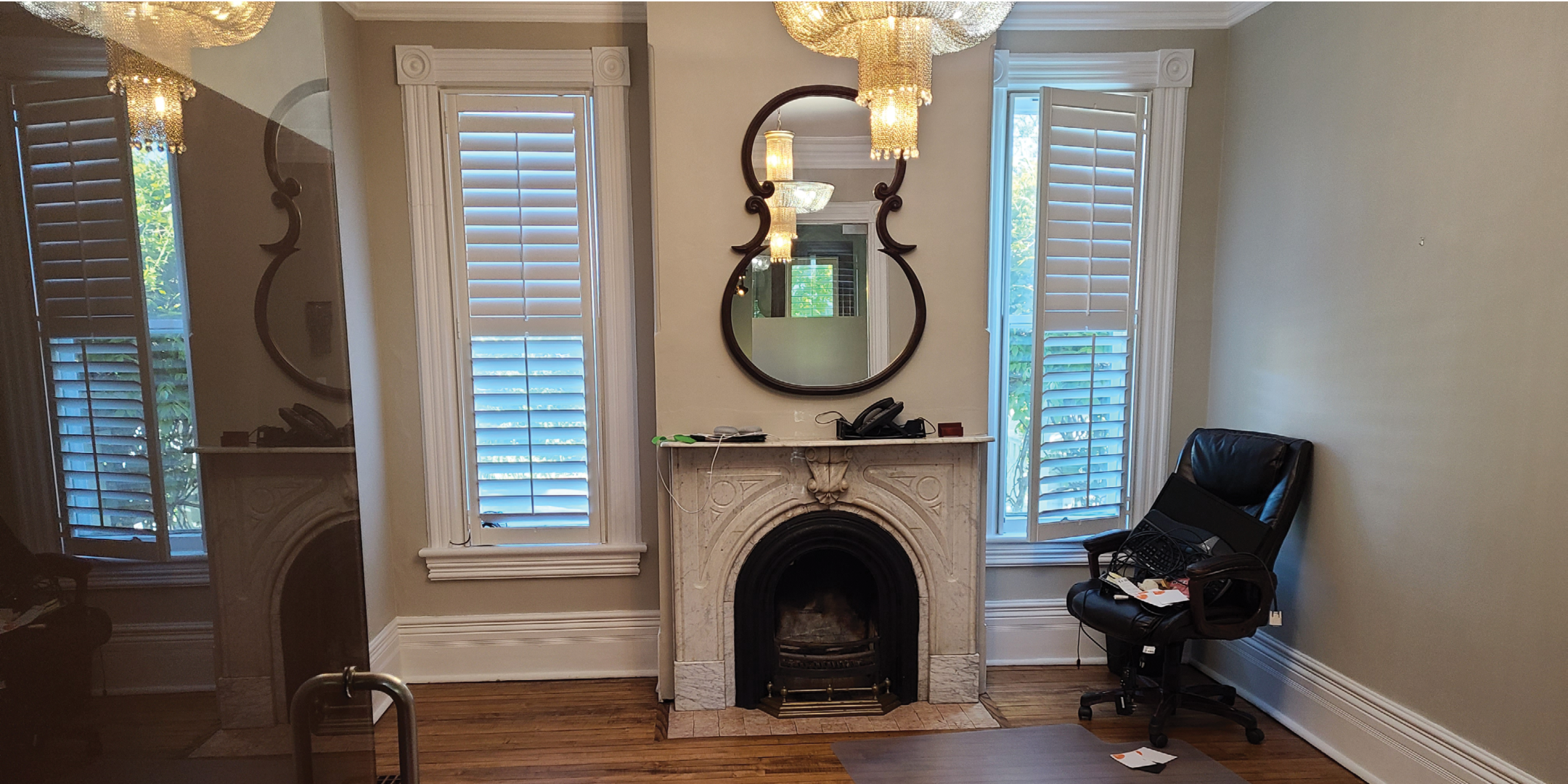 162 Main Street N lounge area with fireplace, vintage mirror and two windows