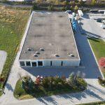 aerial of white precast industrial building