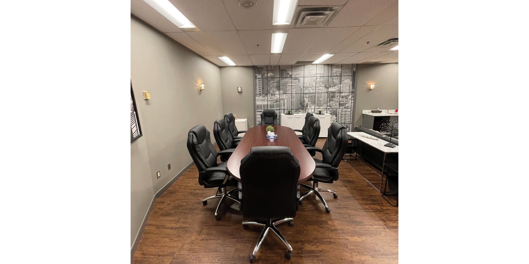 90 Matheson Boardroom with 8 chairs and a painting on the wall