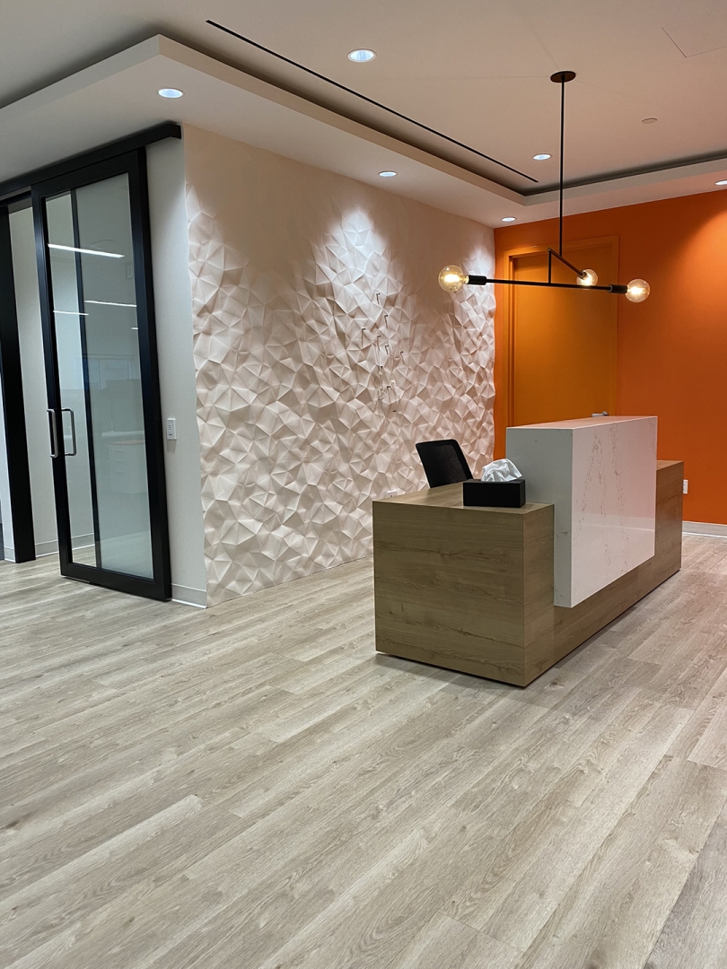 130 King Street W front reception desk with orange wall